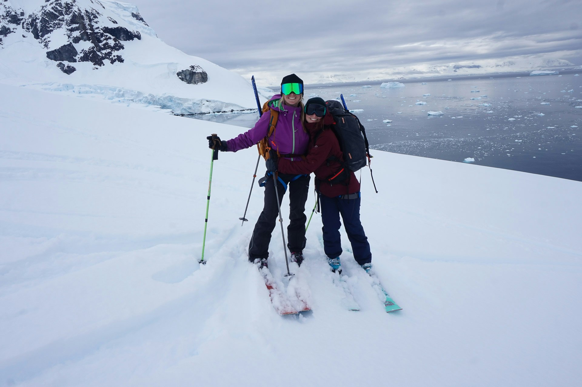 Passengers Hugging after Skiing, Antarctica, Tarn Pilkington