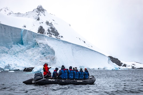 Zodiac Cruising near snowy embankments
